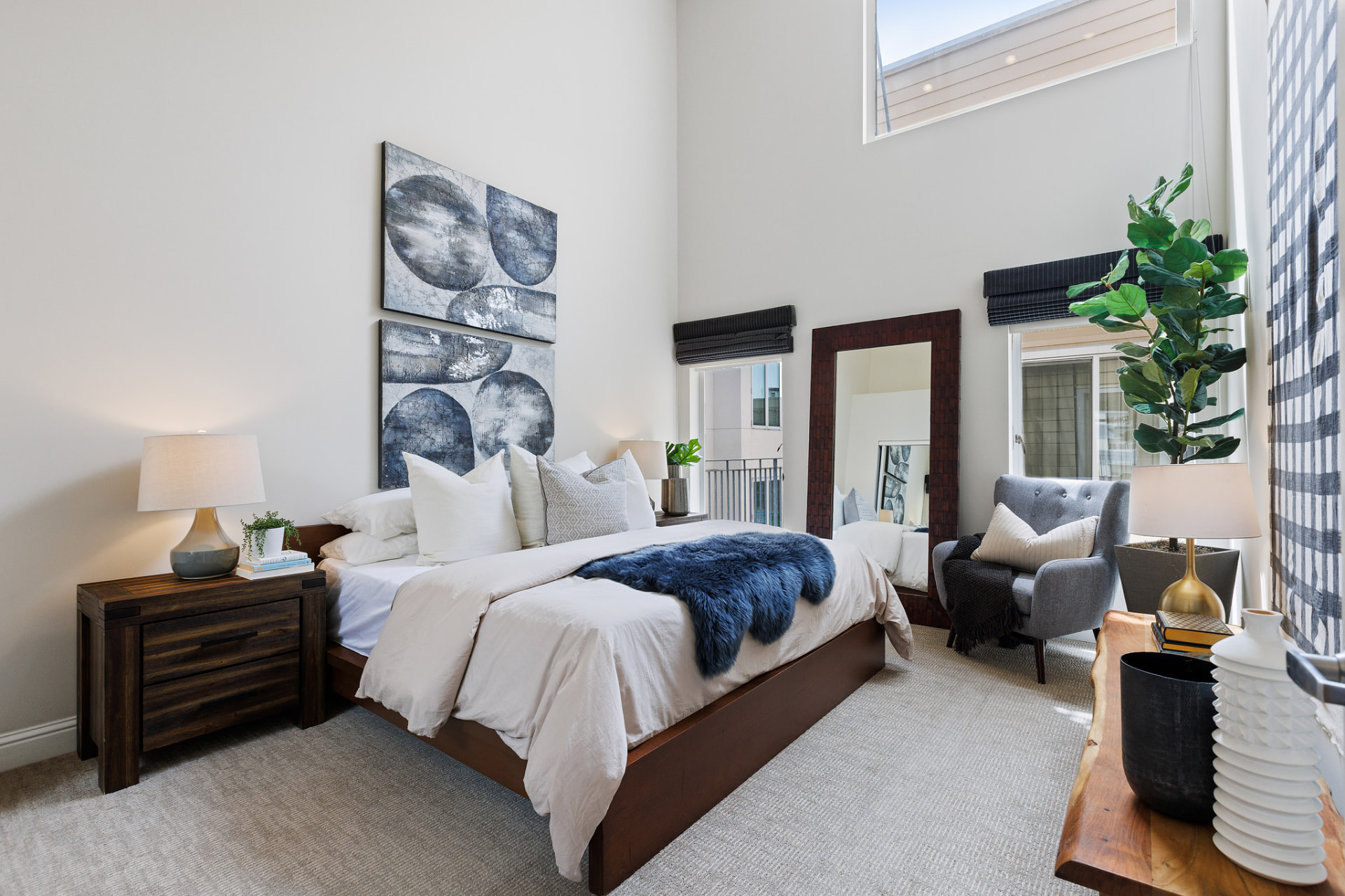 Serene bedroom with high ceilings and abstract art