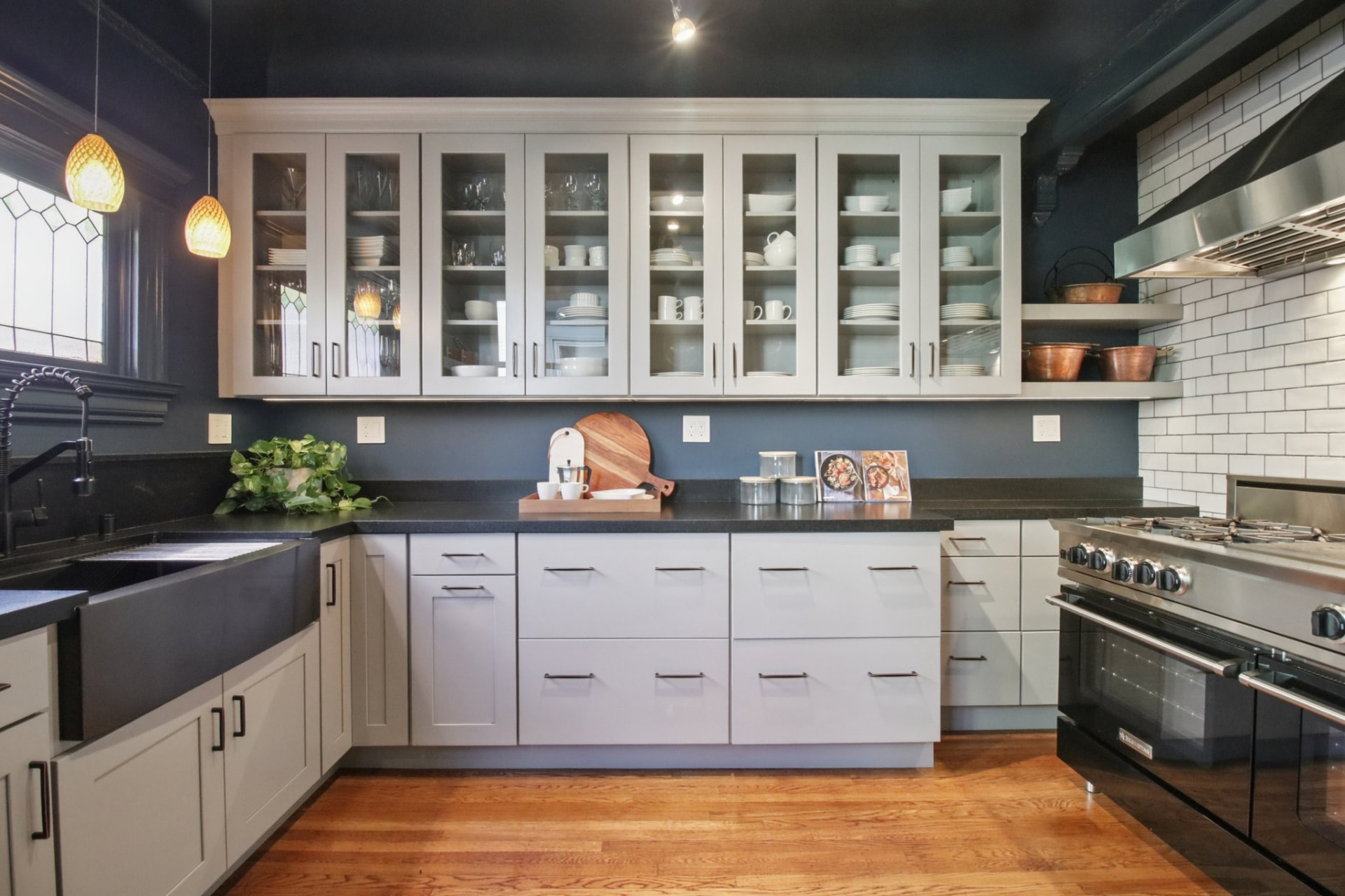 Kitchen at 1328 Waller Street with glass-front cabinetry, subway tile, and professional range