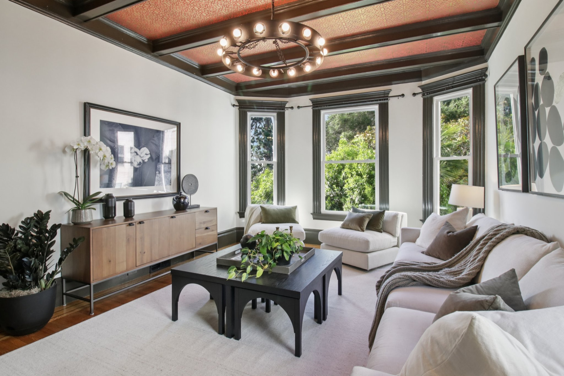 Neutral living room with bay windows and modern furnishings